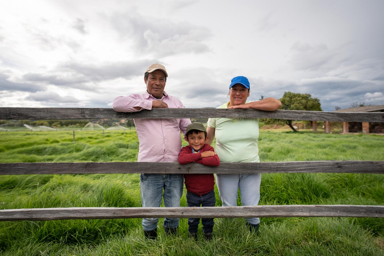 iStock-1319254527 Latin American family looking happy at their farm