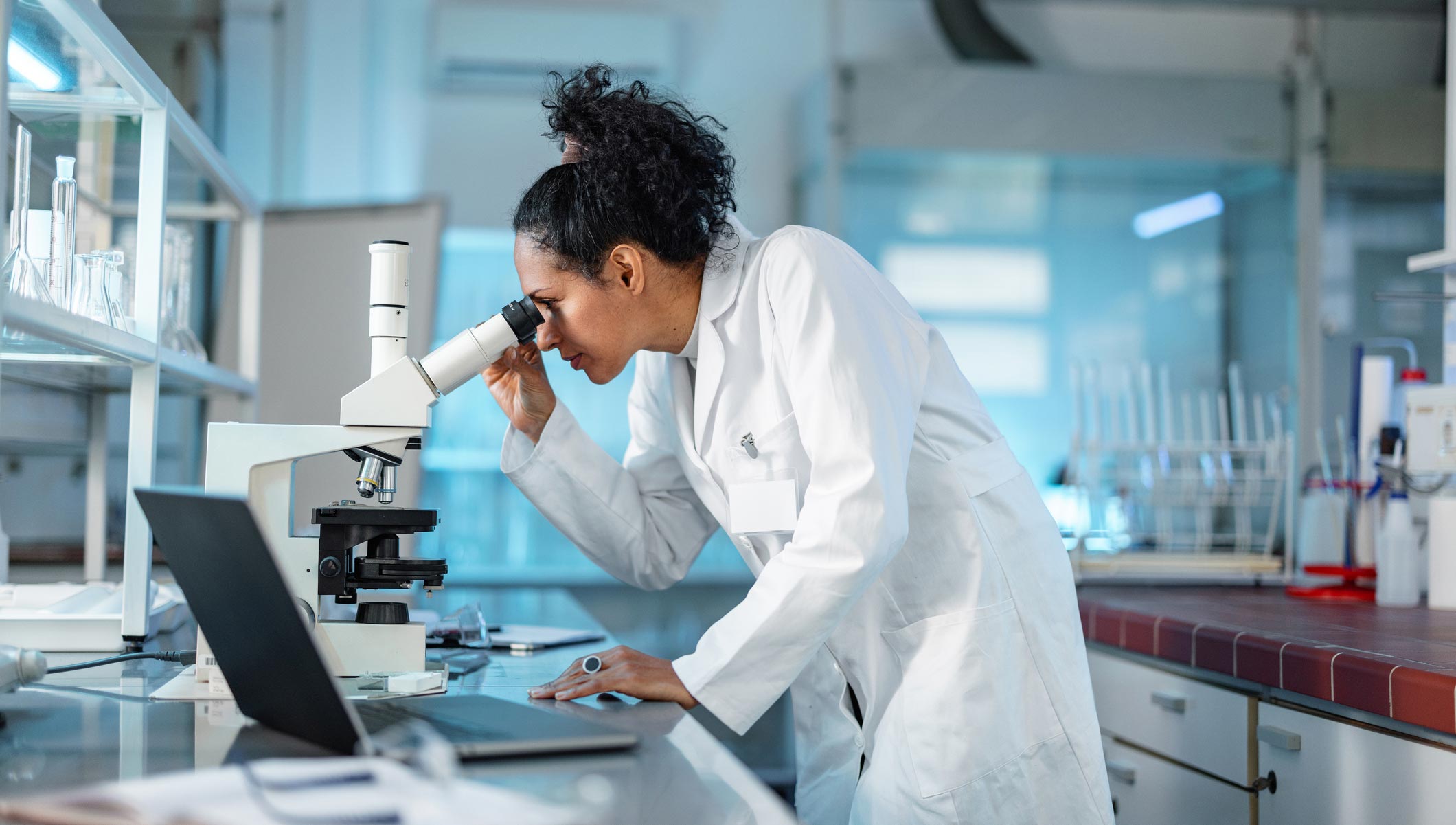 Young Female Scientist Noting Results Of Experiment In A Lab